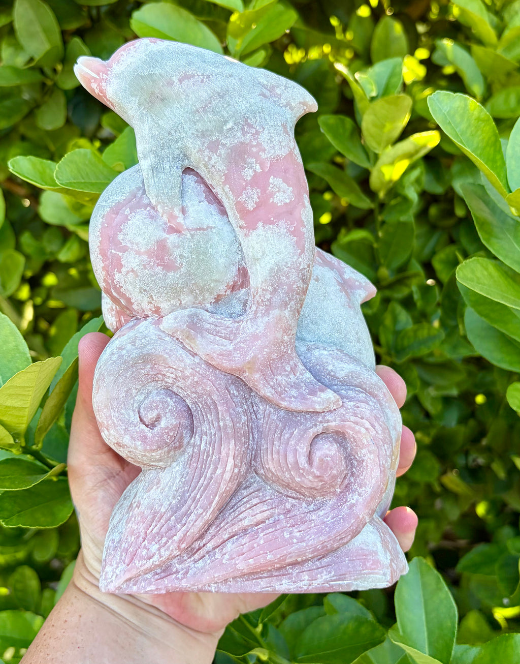 Pink opal dolphin carving