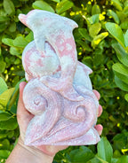 Pink opal dolphin carving
