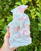 Pink opal dolphin carving