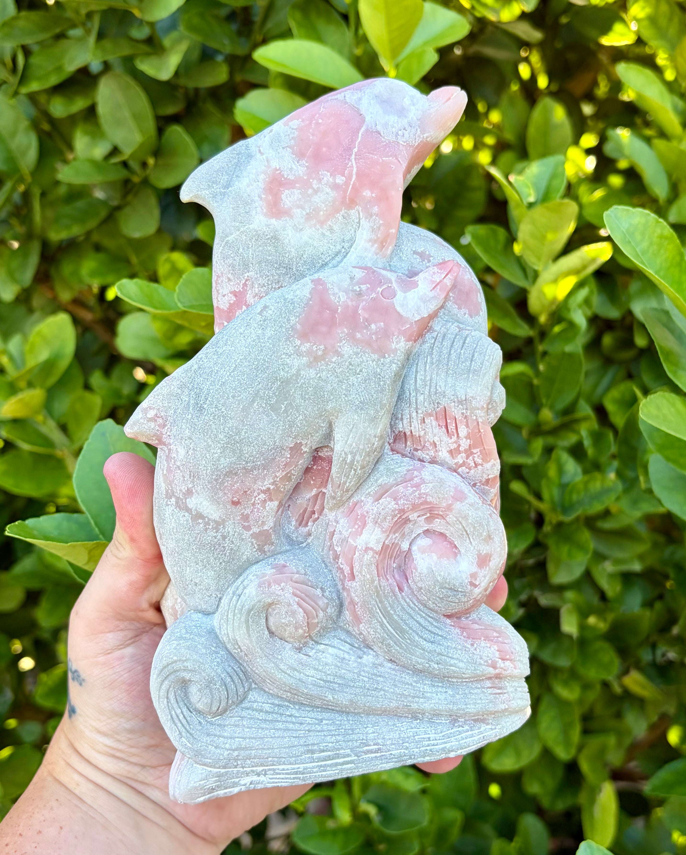 Pink opal dolphin carving